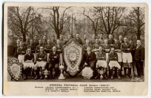 Arsenal Football Club 1930-31’. Mono real photograph postcard of the Arsenal team, staff and directors standing and sitting in rows with a series of trophies on display including the Leagure Championship, Charity Shield etc. Photo by Excel Studios. Title 