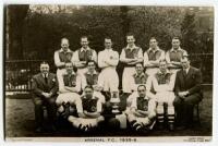 Arsenal Football Club 1935-36’. Mono real photograph plainback postcard of the Arsenal team, staff and management standing and sitting in rows with the F.A. Cup. Postcard by Lambert Jackson. Postally unused. The postcard appears to have been slightly trim