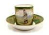 Sevres football cup and saucer. A beautifully made and decorated green & gold porcelain tea cup and saucer, the cup with hand painted image of a footballer inside gilt panel. ‘Sevres’ stamp to base of saucer. The cup stands 2.5” and the saucer is 5” diame