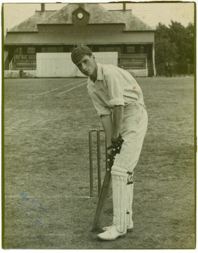 ‘Wilfred Walter Timms. Northamptonshire 1921-1932. Excellent large original photograph of a youthful Timms, wearing cap and in batting stance in front of the wicket with pavilion to background. Signed to image in biro, in later years by Timms, and dated J