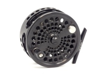 A Phos PH-3.5 #7/8 saltwater fly reel and spare spool, black anodised finish, multi-perforated drum with counter-balanced rosewood handle, rear spindle mounted tension adjuster, as new, in pouch and card boxes and a Stu Apte "Signature Series" 3 piece ca