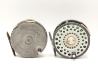A Hardy Perfect 3 3/8" trout fly reel, replacement handle, ribbed brass foot, white agate line guide (one hairline crack), rim tension screw and Mk.II check mechanism, 1930's and a Hardy Zenith 3 ?" wide drummed trout fly reel, alloy foot, two screw drum