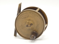 A Hardy Birmingham brass 2 ¼" trout fly reel, tapered horn handle, bridge foot, triple cage pillars, fixed check mechanism, faceplate with raised two screw spindle boss and stamped open oval logo, wear to finish from normal use, circa 1894
