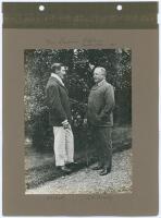 ‘Two Lancashire Captains. Father & Son 1911’. Early mono photograph of A.H. and A.N. Hornby standing facing each other in conversation. The photograph laid down to a photograph album page with handwritten title and names annotated in ink to margins. 6”x8.