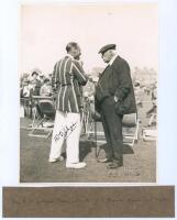 Yorkshire v. M.C.C. Scarborough 1928. Original mono photograph of Frank Gilligan (Essex) wearing striped blazer, in conversation with an elderly C.I. Thornton on the boundary with spectators and deck chairs in the background. Signed to the photograph in b