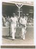 M.C.C. Australian Touring Team v C.I. Thornton’s XI, Scarborough 1928. Original mono photograph of George Geary (Leicestershire) and George Macaulay (Yorkshire) walking out to bat for M.C.C. at Scarborough with the pavilion and crowds in the background fo