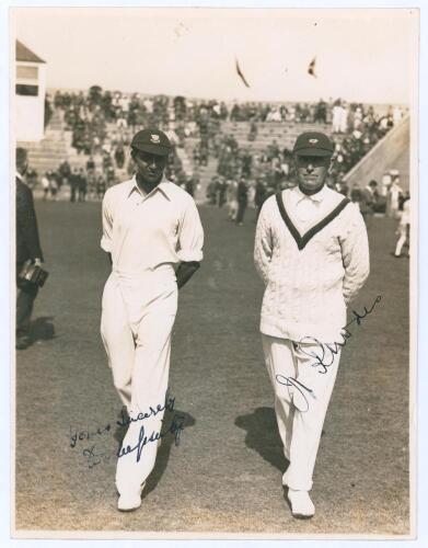 M.C.C. Australian Touring Team v C.I. Thornton&rsquo;s XI, Scarborough 1928. Original mono photograph of K.S. Duleepsinhji (Sussex) and Wilfred Rhodes (Yorkshire) walking side by side on the outfield at Scarborough with crowds in the stands, for the match playe