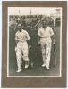 M.C.C. Australian Touring Team v C.I. Thornton&rsquo;s XI, Scarborough 1928. Original mono photograph of Ernest Tyldesley (Lancashire) and Maurice Tate (Sussex) walking walking out to bat for M.C.C. at Scarborough with crowds in the stands in the background, fo