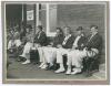 Bill Bowes and Wilfred Rhodes. Yorkshire. Original mono photograph of six players seated on a bench watching play in progress outside the players’ dressing room of a pavilion with spectators seated in the background. Nicely signed in ink to the photograph