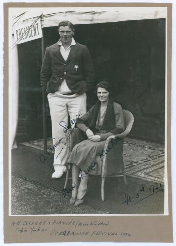 Arthur Brian Sellers. Yorkshire 1932-1948. Original mono photograph of Brian Sellers standing full length wearing cricket attire and Yorkshire blazer with his fianc√©, Miss Bessie Walker, seated beside. The couple are situated in front of the President’s 