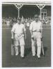 Arthur Wood. Yorkshire & England 1929-1946. Original mono photograph of Wood walking out to bat with Arthur Mitchell for Yorkshire at Scarborough in 1932, possibly the match v. M.C.C. 31st August- 2nd September 1932. The pavilion and spectators in the bac