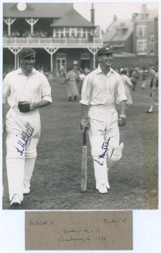 Arthur Mitchell and Len Hutton. Yorkshire v. M.C.C. Scarborough 1936. Original mono photograph of the Yorkshire opening batsmen, Mitchell and Hutton, walking out to bat with smiles on their faces, the pavilion and stand at Scarborough with crowds in the b
