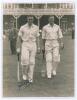 John Richardson and Brian Sellers. Yorkshire v. M.C.C. Scarborough 1936. Original sepia photograph of Yorkshire batsmen Richardson and Sellers walking out to bat, apparently at the start of the second day&rsquo;s play, the pavilion and stand at Scarborough with