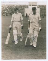 Denys Wilcox and Fred Price. Yorkshire v. M.C.C. Scarborough 1936. Original sepia photograph of M.C.C. batsmen Wilcox and Price walking off the field at Scarborough, the grandstand with crowds in the background, for the match played 2nd- 4th September 193