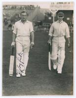 Tom Longfield and Errol Holmes. Yorkshire v. M.C.C. Scarborough 1936. Original mono photograph of M.C.C. batsmen Longfield and Holmes walking out to bat at Scarborough, the pavilion and grandstand with crowds in the background, for the match played 2nd- 4