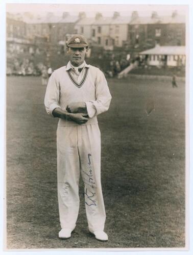 Errol Reginald Thorold Holmes. Surrey, Oxford University & England 1924-1955. Original mono photograph of Errol Holmes standing full length on the outfield at Scarborough, wearing cricket attire and England cap. Annotation in pencil to verso indicates 193