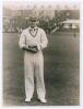 Errol Reginald Thorold Holmes. Surrey, Oxford University & England 1924-1955. Original mono photograph of Errol Holmes standing full length on the outfield at Scarborough, wearing cricket attire and England cap. Annotation in pencil to verso indicates 193