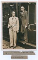 Herbert Sutcliffe. Yorkshire & England 1919-1945. Original sepia press photograph of Sutcliffe and Walter Hammond both wearing suits, standing at the door of a train at St. Pancras Station prior to travelling to Australia for the 1932/33 ‘Bodyline’ tour. 