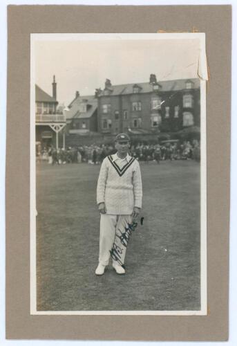 John Berry ‘Jack’ Hobbs. Surrey & England 1905-1934. Original mono real photograph postcard of Hobbs standing full length on the outfield at Scarborough, wearing cricket attire and England cap c.1930. Very nicely signed in ink to the photograph by Hobbs. 