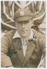Thomas Edwin Reed &lsquo;Tommy&rsquo; Cook. Sussex 1922-1937. Original sepia press photograph of Cook seated half length wearing blazer and Sussex cap, cigarette in mouth. Nicely signed in black ink to the photograph by Cook. The photograph by Sport & General measure
