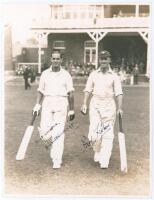 Holmes and Sutcliffe. Scarborough 1928. Original sepia (press?) photograph of Herbert Sutcliffe and Percy Holmes walking out to bat for Yorkshire at Scarborough for the match v M.C.C. 1st- 4th September 1928. Very nicely signed in black ink to the photogr