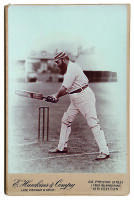 William Gilbert Grace, Gloucestershire, London County & England 1870-1908. Original sepia cabinet card photograph of Grace, wearing a hooped cap, playing a shot at the wicket. Photograph by E. Hawkins of Brighton. Photographers name and address printed to