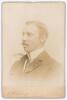 Alfred Edward Johns. Victoria 1894-1899. Sepia cabinet card photograph of Johns, head and shoulders, in formal wear wearing suit, dress shirt and tie. Cabinet card by A. Pickering of Leicester. Slight fading to image, very minor marks to image surface and