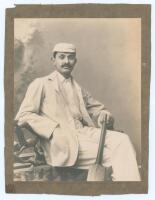 Kumar Shri Ranjitsinhji. Cambridge University, Sussex & England 1893-1920. Excellent large original studio portrait photograph of a young Ranji, seated three quarter length wearing cricket attire and what appears to be a Cambridge University cap and blaze