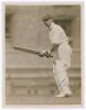 Andrew Sandham. Surrey & England 1911-1937. Original sepia press photograph of Sandham in batting action wearing his England cap. Very nicely signed in blue ink to the photograph by Sandham. Official stamp for Central Press Photos to verso. 6.5&rdquo;x8.5&rdquo;. Ver