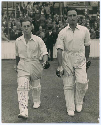 Middlesex C.C.C. 1947. Denis Compton and Bill Edrich. Large original mono press photograph of Compton and Edrich walking out to bat in 1947. Signed in ink to the photograph by both players. Central Press Photos, London. 8&rdquo;x10&rdquo;. Small wear to lower right c