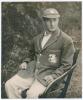 Alfred Percy &lsquo;Tich&rsquo; Freeman. Kent & England 1914-1936. Large original mono photograph of Freeman three quarter length wearing M.C.C. tour cap and blazer, seated in a garden chair. The photograph by B. & W. Fisk-Moore of Canterbury, laid to tightly trimmed