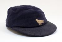 Sussex navy blue 2nd XI cloth cricket cap worn by Robin Marlar during his playing career. The cap, by W.V. Brown of Eton, embroidered with the single martlet emblem of Sussex to front. The cap is worn and a little faded, with odd faults, odd moth hole etc