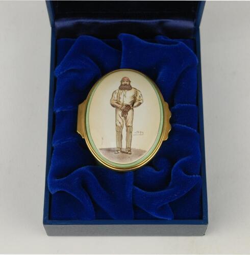 &lsquo;W.G. Grace&rsquo;. Halcyon Days oval enamelled pill box. The lid decorated with full length figure of Grace by &lsquo;Spy&rsquo;, biographical details of Grace to the inside of the lid, the inside base with inscription, &lsquo;W.G. Grace, 1848-1915. Hero of English Cricket&rsquo;. St