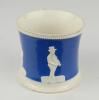 Staffordshire blue ground waisted cricket mug with strap handle and beaded rim. With three relief moulded figures of a batsman, bowler and wicket keeper in cream, believed to be Lillywhite, Pilch and Box. c1860. Very minor wear to rim, minor wear to base - 2