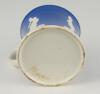 Staffordshire blue ground waisted cricket mug with strap handle and beaded rim. With three relief moulded figures of a batsman, bowler and wicket keeper in cream, believed to be Lillywhite, Pilch and Box. c1860. Very minor wear to rim, minor wear to base - 4