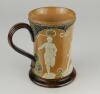 Doulton Lambeth stoneware waisted body tankard with art noveau designs of stylised hearts and white on blue dots, with sporting figures in relief in white showing two footballers with ball, athletics runner and shot putting. 6&rdquo; tall. Impressed Doulton Lam - 3