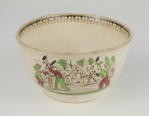 Village cricket bowl. Staffordshire 19th century bowl, transfer printed in sepia with three scenes of village cricket, with church and tents to background, to sides, floral and oak leaf inner rim decoration. Hand coloured in green, burgundy and black. App