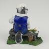 &lsquo;The Badger Spectator&rsquo;. A handmade and painted figure of a ageing badger sitting on a bench, with knotted handkerchief on his head, eating his lunch and holding an umbrella. 5.25&rdquo; tall. No Makers mark and date apparent to base. A excellent detailed figure - 2