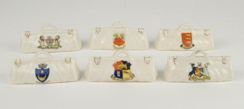 Cricket bags. Six very large crested china cricket bags with colour emblems for Bristol, Church, Portsmouth, Modbury, Wood Green and Bradford. Various makers. Each approx 4.5&rdquo; long. Sold with five 1960&rsquo;s (?) cricket rosettes for Nottinghamshire (2), Leice