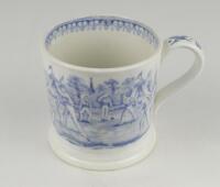 Village cricket mug. Staffordshire 19th century mug, transfer printed in pale blue with two scenes of village cricket to either side, with church and tents to background, floral and oak leaf rim decoration and crossed cricket bats, balls and stumps decora