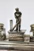 Cricket desk set. Large and impressive silver plated cricket ink stand consisting of a central detachable section with figure of a batsman posed in front of the wicket to lid, two glass ink pots with plated lids on a oblong stand with pen rests to both si - 2