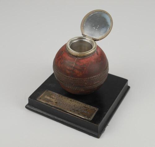 Cricket ball inkwell. The leather cricket ball mounted to wooden base with ink well inserted to the top of the ball, silver opening lid. The ink well was presented as ‘A Token of appreciation from the members of Epps Cricket Club 1932’. The lid and inkwel