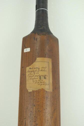 A late one-piece cricket bat. An mid 19th Century one-piece cricket bat made by John Thompson of Windsor and dated 1848. The bat is unspliced, narrow and straight shouldered with am unusually slightly convex face and the back of the blade is humped. The 