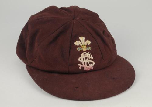 Arnold Long. Surrey and Sussex 1960-1980. Surrey C.C.C. chocolate brown county 1st XI cricket cap by Jack Hobbs Ltd, with crest of the Prince of Wales feathers above the county emblem embroidered to front. Some wear to peak with small hole and some wear, 