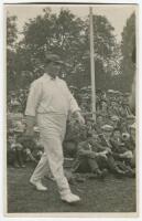 Warwick Windridge Armstrong. Victoria & Australia. 1898-1921. Mono real photograph postcard of Armstrong walking on to the pitch wearing Australian cap with the crowd behind him, possibly on the 1921 tour. Publisher unknown. Good/very good condition