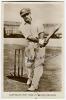 Donald George Bradman. New South Wales, South Australia & Australia 1927-1949. Mono real photograph postcard of Bradman batting at the wicket wearing South Australian cap. Title to lower border &lsquo;Australian Test Team d. (Don) Bradman&rsquo;. Signed to image by B