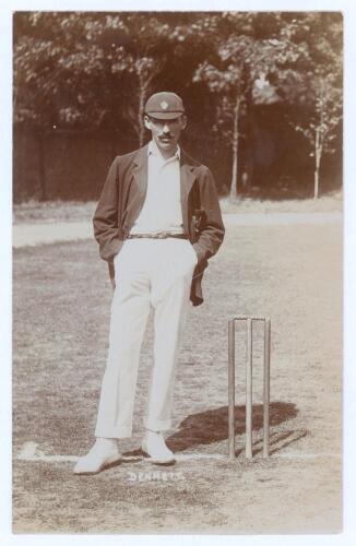 Edward George Dennett. Gloucestershire 1903-1926. Original mono real photograph postcard of Dennett standing full length at the crease wearing cricket attire, blazer and Gloucestershire cap, hands in pockets. Foster of Brighton. Postally unused. Very good