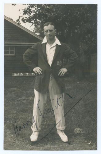 Harry Smith. Gloucestershire & England 1912-1935. Original mono real photograph postcard of Smith standing full length wearing cricket attire and Gloucestershire blazer, hands on hips. Printed title &lsquo;Smith, H.W. [sic]&rsquo; to image. Signed in ink to the photo