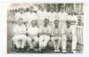 Hampshire C.C.C. 1921. Original mono real photograph plain back postcard of the 1921 Hampshire team seated and standing in rows wearing cricket attire and some caps in front of the pavilion. Ex John Arlott collection with title and players’ names neatly a