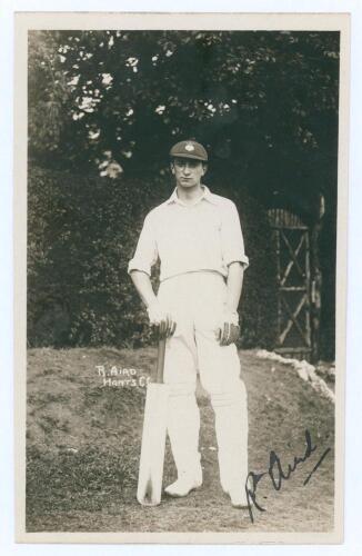 Ronald ‘Ronnie’ Aird. Hampshire & Cambridge University 1920-1938. Original mono real photograph postcard of Aird standing full length wearing cricket attire and Hampshire cap, leaning on his bat. Signed in black ink to the image by Aird. Publisher unknown